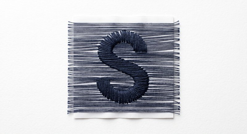 The SuperLoom S, embroidered in thread on fabric.